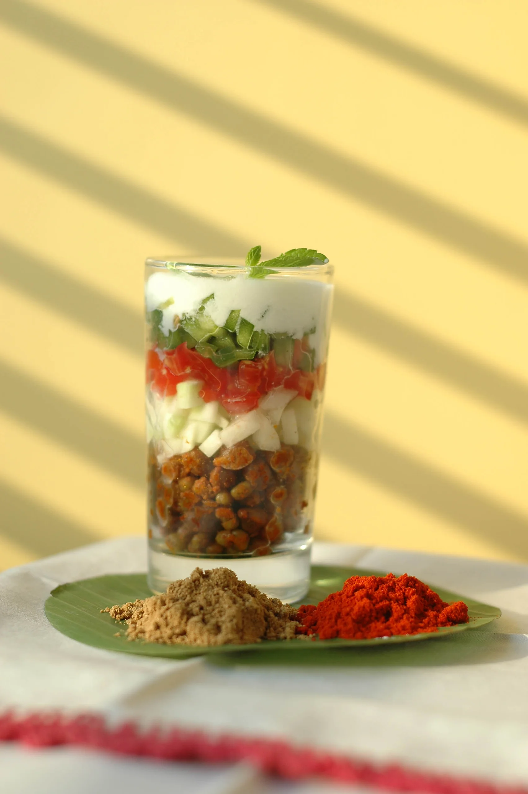 A layered chaat served in a glass at Soam, Babulnath, Mumbai